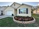Tan house with two-car garage and landscaping at 5240 11Th E St, Bradenton, FL 34203