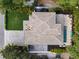 Stunning aerial view of a home with lush landscaping, a pool, and a meticulously maintained roof and backyard at 577 Venice Ln, Sarasota, FL 34242