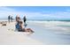 Relaxing beach scene with people enjoying the sun and surf, highlighting a perfect day on the sandy shore at 577 Venice Ln, Sarasota, FL 34242