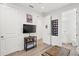 Bedroom with hardwood floors, mounted TV, and view of the powder room at 577 Venice Ln, Sarasota, FL 34242