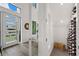 Bright foyer with modern white door, wood floors, wine storage, and recessed lighting at 577 Venice Ln, Sarasota, FL 34242
