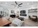 Bright living room with a modern fireplace, a large television, and comfortable seating arrangement at 577 Venice Ln, Sarasota, FL 34242