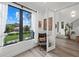 Modern room with large windows, comfortable chair, staircase and view of front yard at 577 Venice Ln, Sarasota, FL 34242