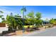 Bright yellow restaurant featuring outdoor benches, lush landscaping, and inviting street-side appeal at 577 Venice Ln, Sarasota, FL 34242