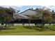 Green backyard features a covered, screened in porch with lovely details at 7234 Cloister Dr # 7234, Sarasota, FL 34231