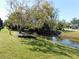 Backyard view of water feature and verdant green space at 7234 Cloister Dr # 7234, Sarasota, FL 34231