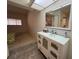 Bathroom vanity with a skylight view of the mirror at 7234 Cloister Dr # 7234, Sarasota, FL 34231