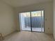 Bright bedroom with sliding glass doors to a patio, neutral carpet and blank walls at 7234 Cloister Dr # 7234, Sarasota, FL 34231