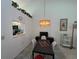 Bright dining area with a chandelier, view into the kitchen, and tile flooring at 7234 Cloister Dr # 7234, Sarasota, FL 34231