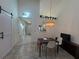 Dining area with high ceilings, a stylish chandelier, and a view of the kitchen at 7234 Cloister Dr # 7234, Sarasota, FL 34231