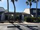 Condo featuring lush landscaping, a walkway to the front door, and palm trees at 7234 Cloister Dr # 7234, Sarasota, FL 34231