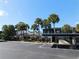 Condo complex featuring palm trees, ample parking, and well-maintained landscaping at 7234 Cloister Dr # 7234, Sarasota, FL 34231