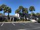 Condo complex featuring palm trees, ample parking, and well-maintained landscaping at 7234 Cloister Dr # 7234, Sarasota, FL 34231