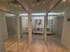 Hallway with mirrored closet doors and double vanity bathrooms at 7234 Cloister Dr # 7234, Sarasota, FL 34231