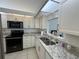Kitchen with granite counters, a double sink, and ample cabinet storage at 7234 Cloister Dr # 7234, Sarasota, FL 34231