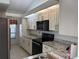 Modern kitchen with granite countertops, stainless steel appliances, and ample cabinet space at 7234 Cloister Dr # 7234, Sarasota, FL 34231