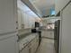 Bright kitchen features granite counters, stainless steel appliances, and skylight at 7234 Cloister Dr # 7234, Sarasota, FL 34231