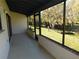 Tiled lanai with stunning backyard views and stream beyond at 7234 Cloister Dr # 7234, Sarasota, FL 34231