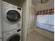 Laundry room area features stackable washer and dryer at 7234 Cloister Dr # 7234, Sarasota, FL 34231