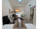 Open living room with a chandelier and sliding barn door at 7234 Cloister Dr # 7234, Sarasota, FL 34231