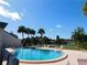 Community pool overlooks manicured grounds and the waterway at 7234 Cloister Dr # 7234, Sarasota, FL 34231