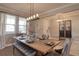 Inviting dining room with a long wooden table and chandelier; perfect for gatherings at 8926 Shadyside Ln, Land O Lakes, FL 34637