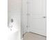 Modern bathroom with gray tile and a white bathtub at 2630 Beeville Ave, North Port, FL 34286
