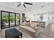 Bright living room with sliding doors to patio and fireplace at 577 Venice Ln, Sarasota, FL 34242