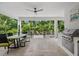 Outdoor kitchen with stainless steel grill and dining area at 577 Venice Ln, Sarasota, FL 34242