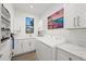 Bright laundry room with white cabinets and modern appliances at 577 Venice Ln, Sarasota, FL 34242