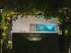 Nighttime aerial view of a home with a lit pool and patio at 577 Venice Ln, Sarasota, FL 34242