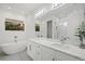 Modern bathroom with double vanity, soaking tub, and walk-in shower at 577 Venice Ln, Sarasota, FL 34242