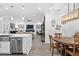 Modern kitchen with a large island, stainless steel appliances, and a dining area at 577 Venice Ln, Sarasota, FL 34242
