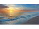 Stunning sunset over ocean waves on sandy beach at 577 Venice Ln, Sarasota, FL 34242