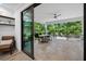 Relaxing covered patio with outdoor furniture and tropical views at 577 Venice Ln, Sarasota, FL 34242
