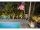 Tranquil pool area with a soothing water fountain feature at 577 Venice Ln, Sarasota, FL 34242