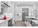 Modern kitchen with white cabinets, a large island, and a farmhouse sink at 577 Venice Ln, Sarasota, FL 34242