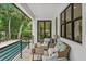 Comfortable wicker furniture and a coffee table create a relaxing space on this patio at 577 Venice Ln, Sarasota, FL 34242
