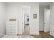 Bright hallway with light wood floors and access to bedrooms at 577 Venice Ln, Sarasota, FL 34242