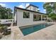 Private backyard oasis with a pool, patio, and water feature at 577 Venice Ln, Sarasota, FL 34242