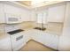 Efficient kitchen with white cabinets and modern appliances at 3961 Ashwood Ln # 44, Sarasota, FL 34232