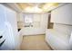 Galley style kitchen with white cabinets and modern appliances at 3961 Ashwood Ln # 44, Sarasota, FL 34232