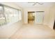 Main bedroom with carpet flooring and access to a sunroom at 3961 Ashwood Ln # 44, Sarasota, FL 34232