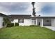 Front view of a villa with a carport and well-maintained lawn at 3961 Ashwood Ln # 44, Sarasota, FL 34232