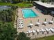 Community pool with surrounding patio furniture and lush landscaping at 3961 Ashwood Ln # 44, Sarasota, FL 34232