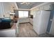 Simple kitchen with white cabinets and light grey wood-look flooring at 3961 Ashwood Ln # 44, Sarasota, FL 34232
