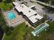 Aerial view of community pool, patio furniture, and shuffleboard at 3961 Ashwood Ln # 44, Sarasota, FL 34232