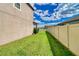 Landscaped side yard with a fence and access to backyard at 8926 Shadyside Ln, Land O Lakes, FL 34637