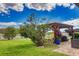 Landscaped backyard with a pergola and seating area at 8926 Shadyside Ln, Land O Lakes, FL 34637