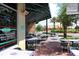 Outdoor patio seating area with tables and chairs, located near a restaurant at 6527 Moorings Point Cir # 101, Lakewood Ranch, FL 34202
